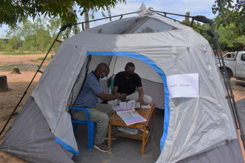 MOH nurse demonstrating the HIV self-test procedure to Dr. Otto